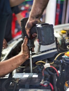 Auto mechanic repairing car. Selective focus.